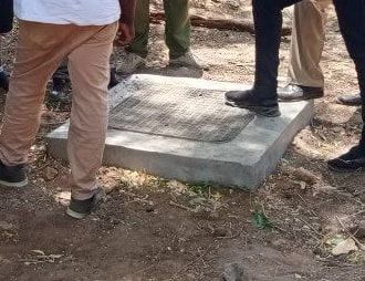 People in work boots standing around a new inspection chamber cover.