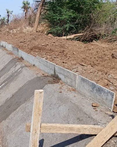 Fresh concrete canal lining with timber setting-out pegs.